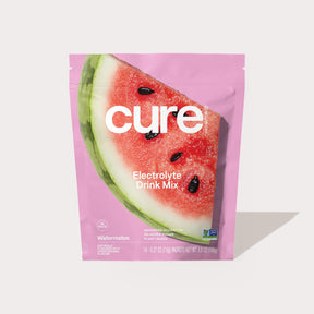 Cure Electrolyte Drink Mix Watermelon flavor packet with watermelon image on pink background