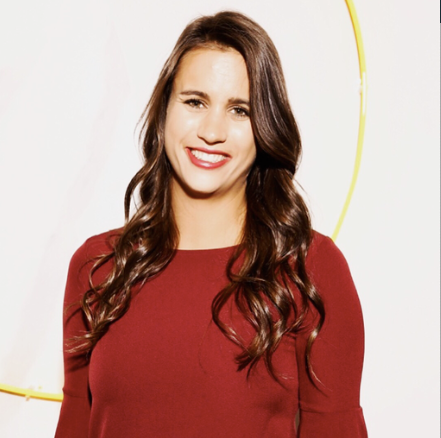 Smiling woman with long brown hair wearing a red top